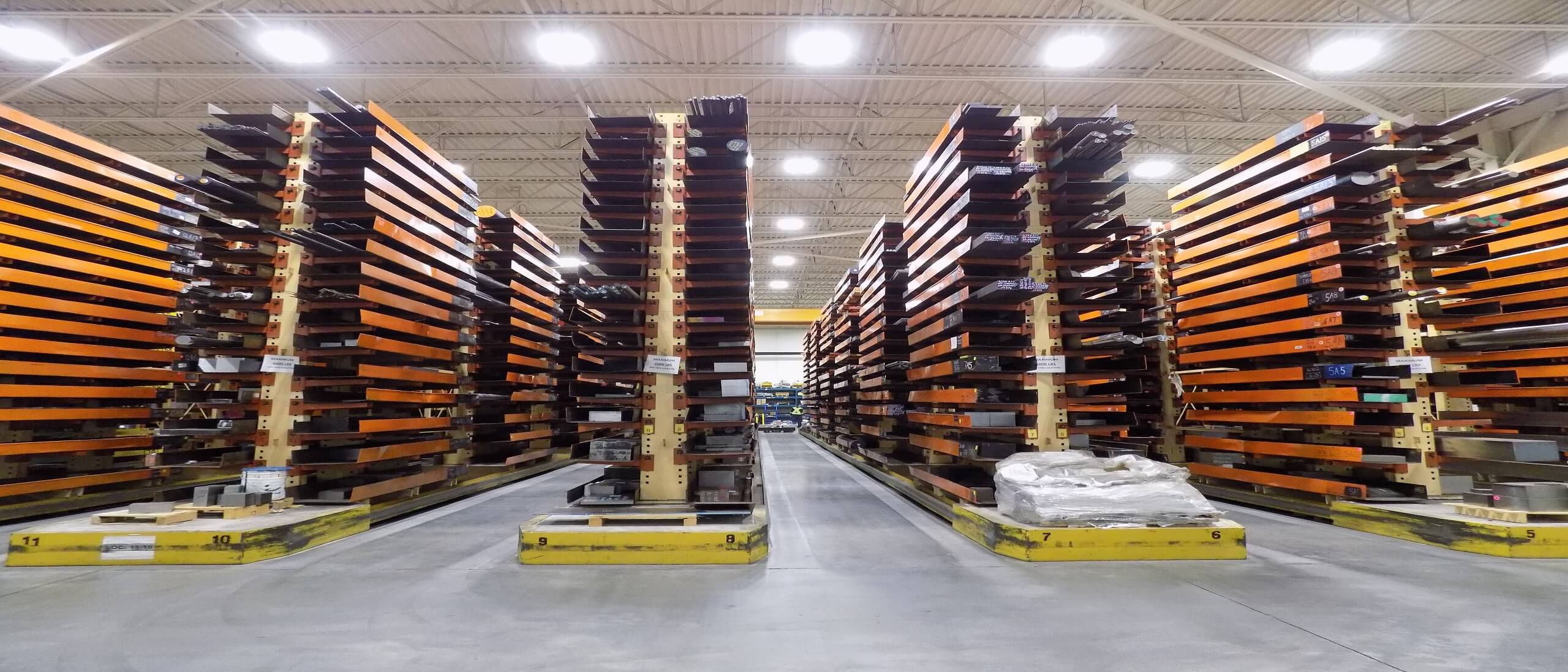Warehouse with racks, steel bars in pans on shelves